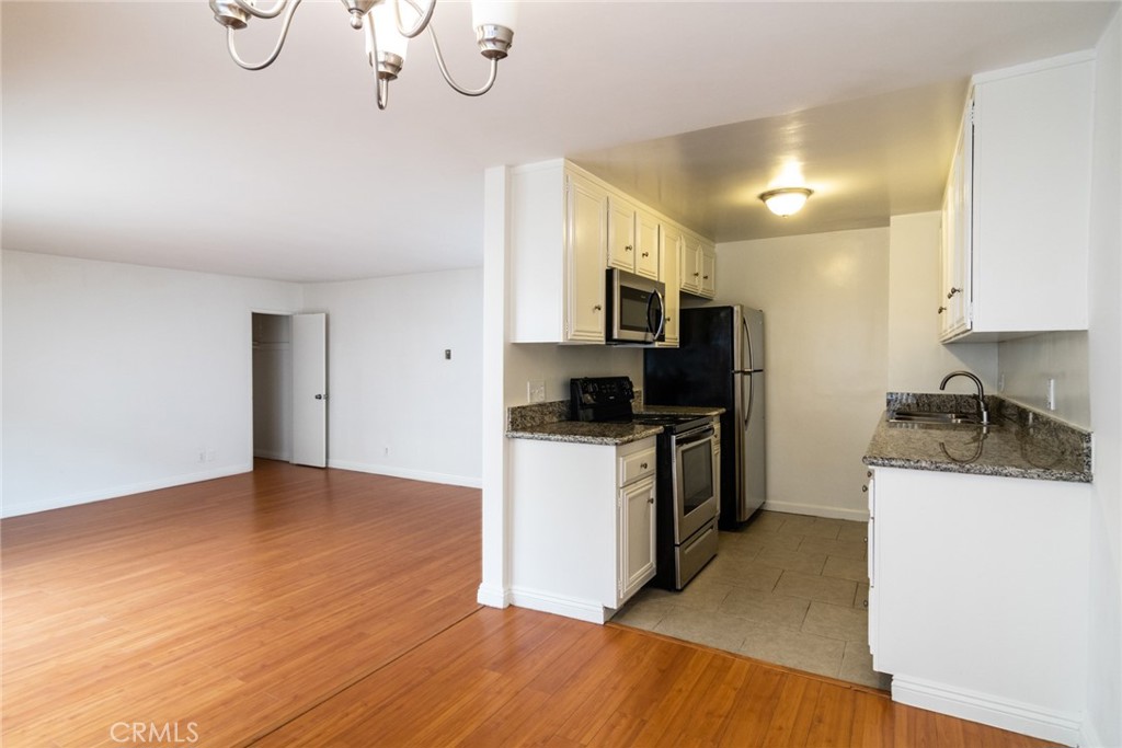 1122 9th Street, Unit 4 Santa Monica, CA 90403 - Photo 9 of 18 a kitchen with a sink a microwave a stove and refrigerator