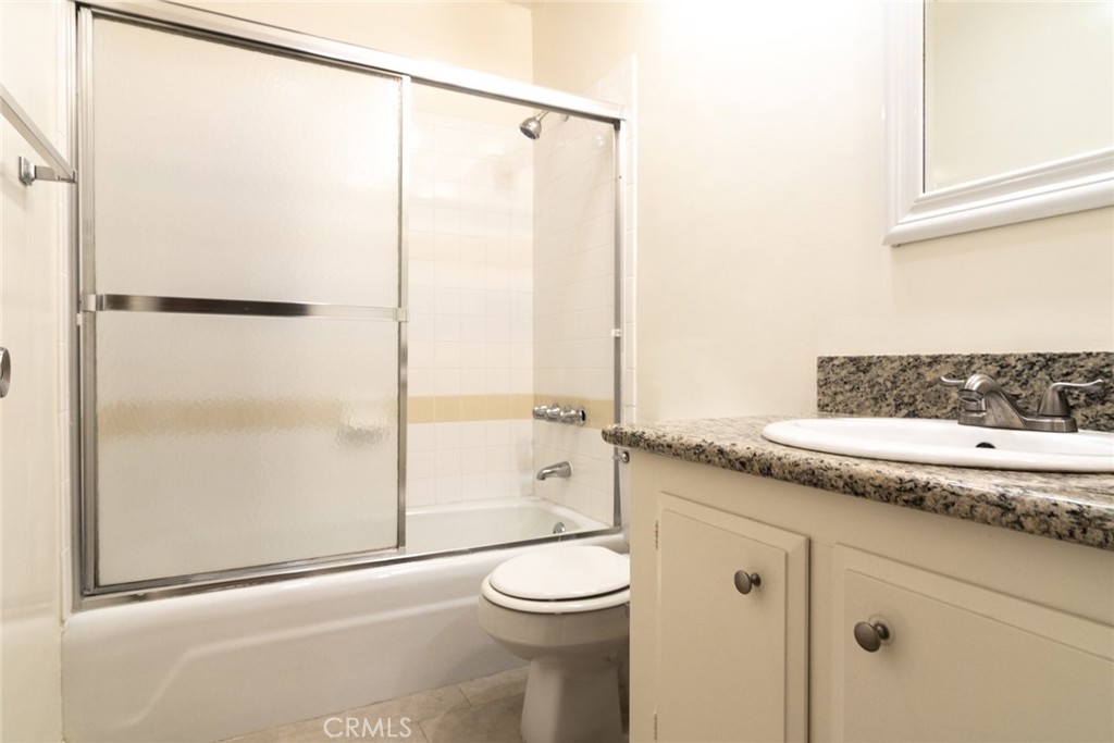 1122 9th Street, Unit 4 Santa Monica, CA 90403 - Photo 10 of 18 a bathroom with a granite countertop sink toilet and shower