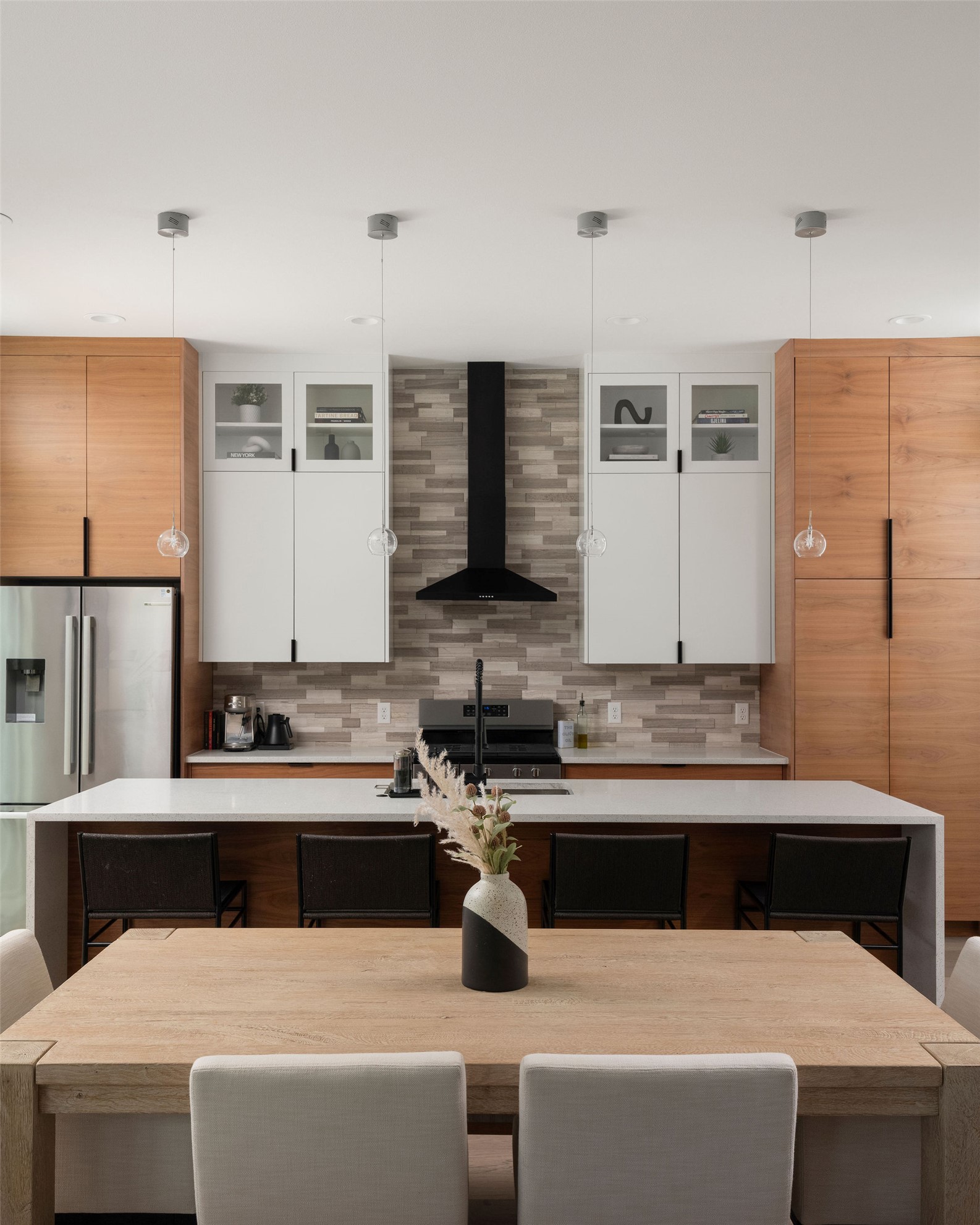 3710 Manorwood Road Austin, TX 78723 - Photo 12 of 40 A well-appointed culinary space featuring sleek cabinetry, an expansive kitchen island, and contemporary lighting.