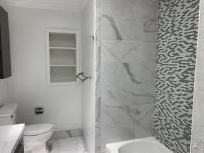 a bathroom with a toilet and shower