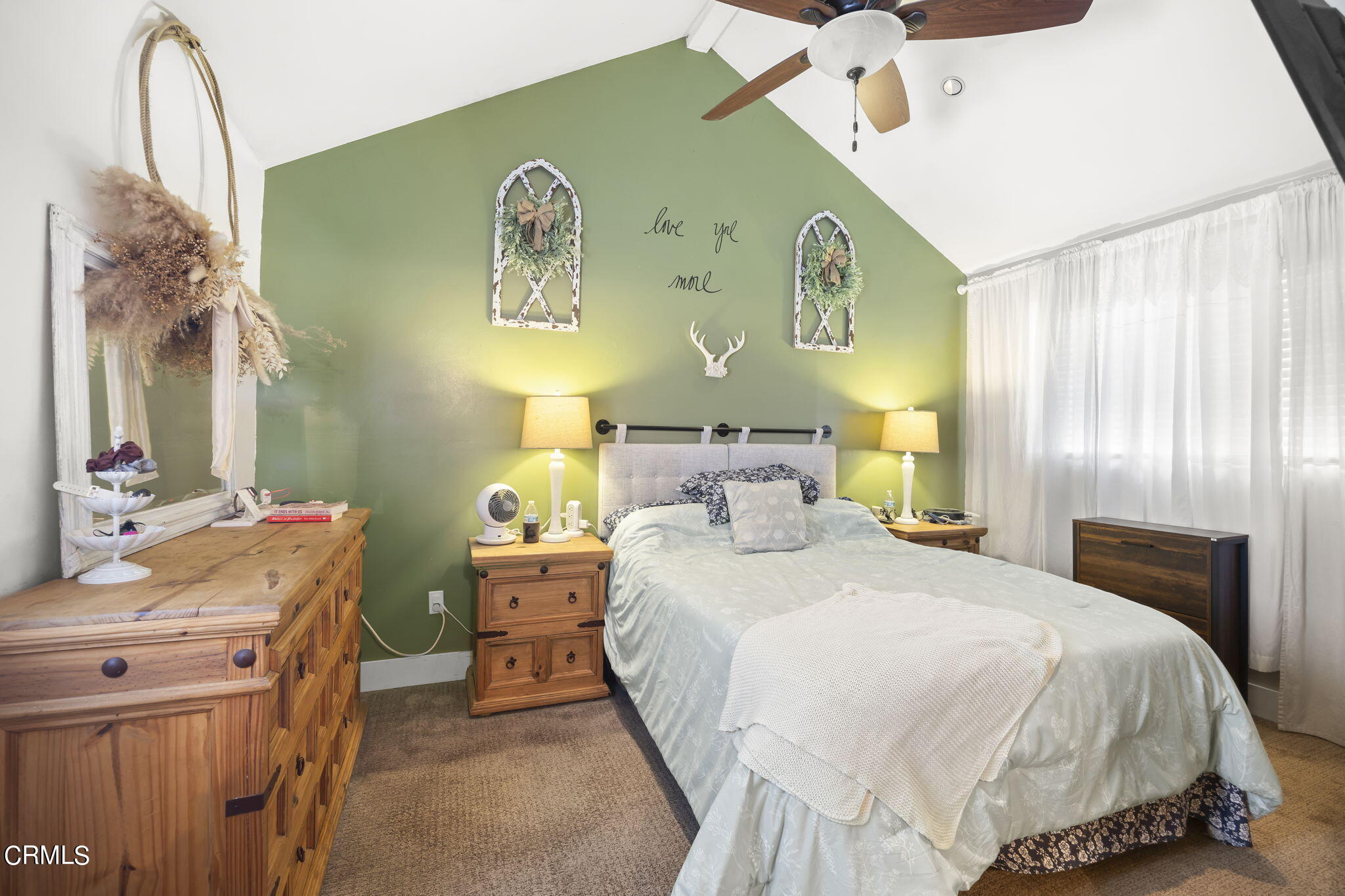 929 Devereux Drive Ojai, CA 93023 - Photo 16 of 40 a bedroom with a bed and a chandelier