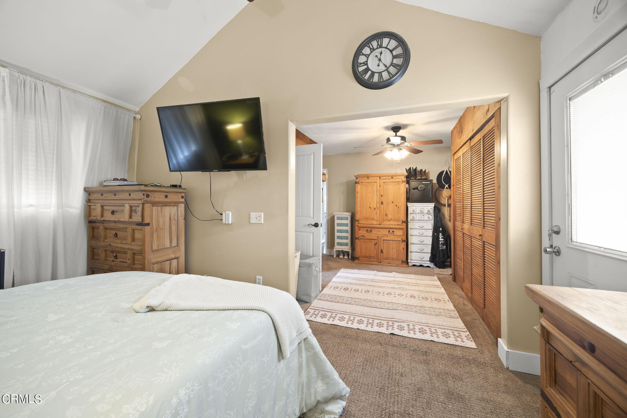 929 Devereux Drive Ojai, CA 93023 - Photo 17 of 40 a bedroom with a bed and a flat screen tv