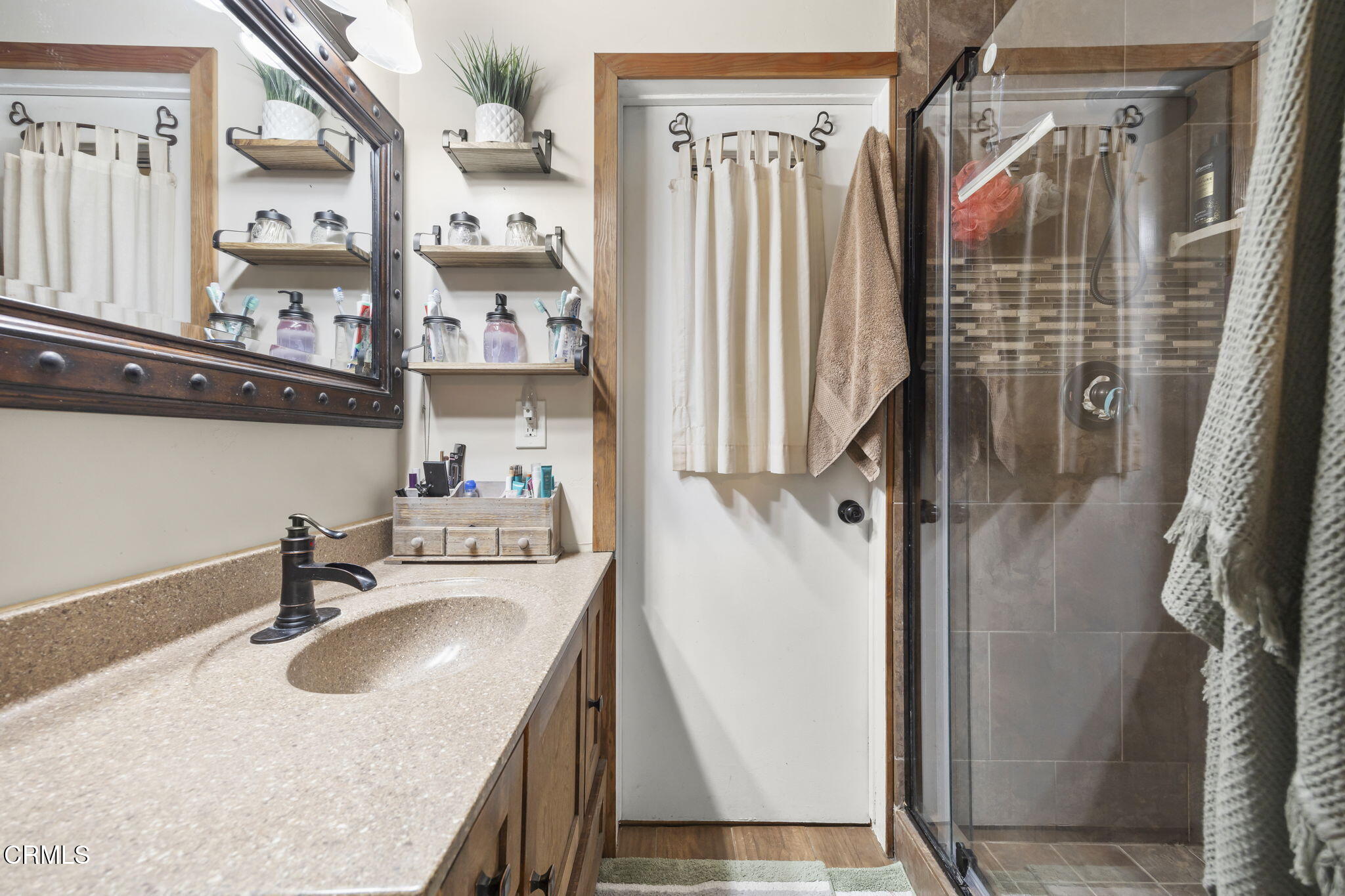 929 Devereux Drive Ojai, CA 93023 - Photo 20 of 40 a bathroom with sink a mirror a bathtub and shower