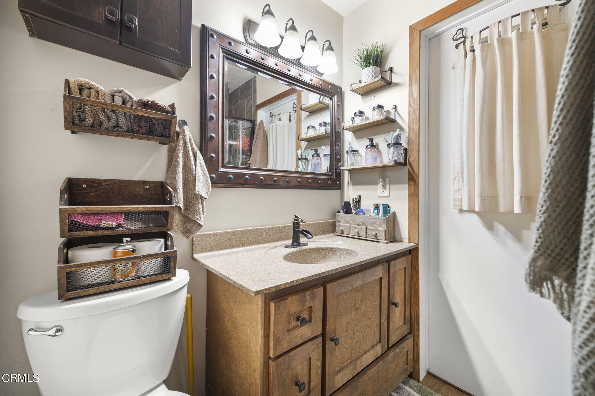 929 Devereux Drive Ojai, CA 93023 - Photo 21 of 40 a bathroom with a sink a toilet and a mirror