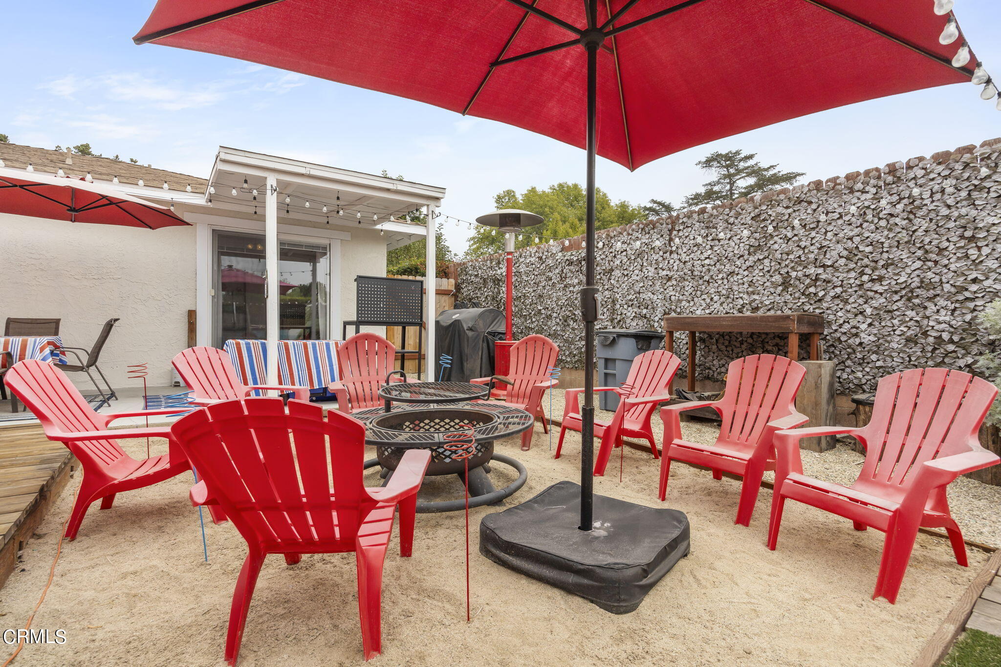929 Devereux Drive Ojai, CA 93023 - Photo 31 of 40 a patio with a table and chairs under an umbrella