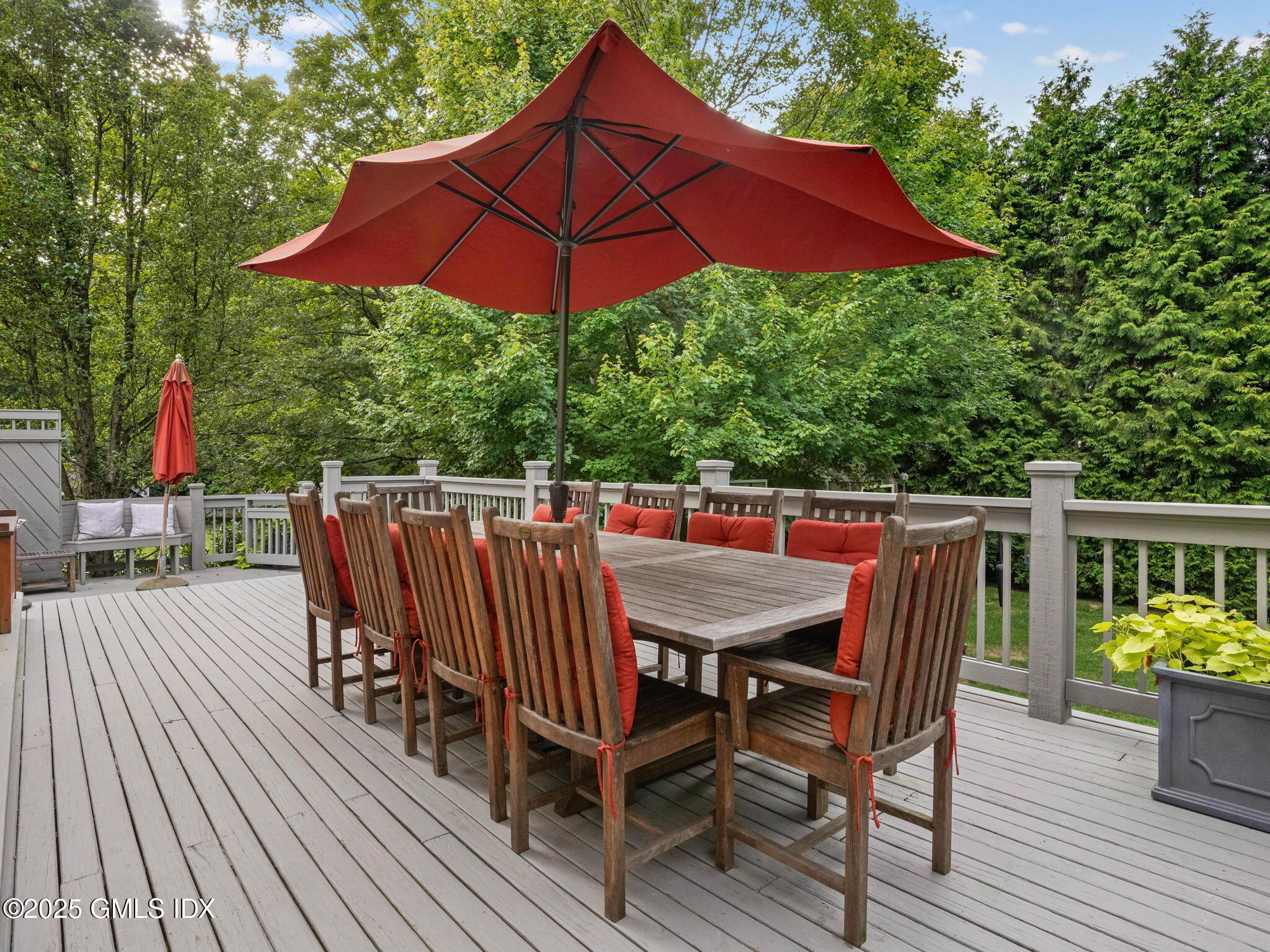 143 Lockwood Road Riverside, CT 06878 - Photo 27 of 39 a view of deck with dinning table and chair under an umbrella with wooden floor
