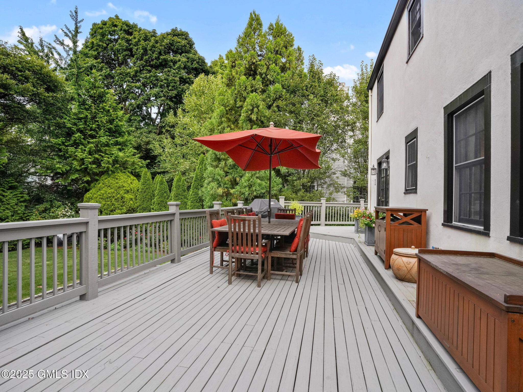 143 Lockwood Road Riverside, CT 06878 - Photo 29 of 39 a view of a roof deck with table and chairs under an umbrella with wooden floor