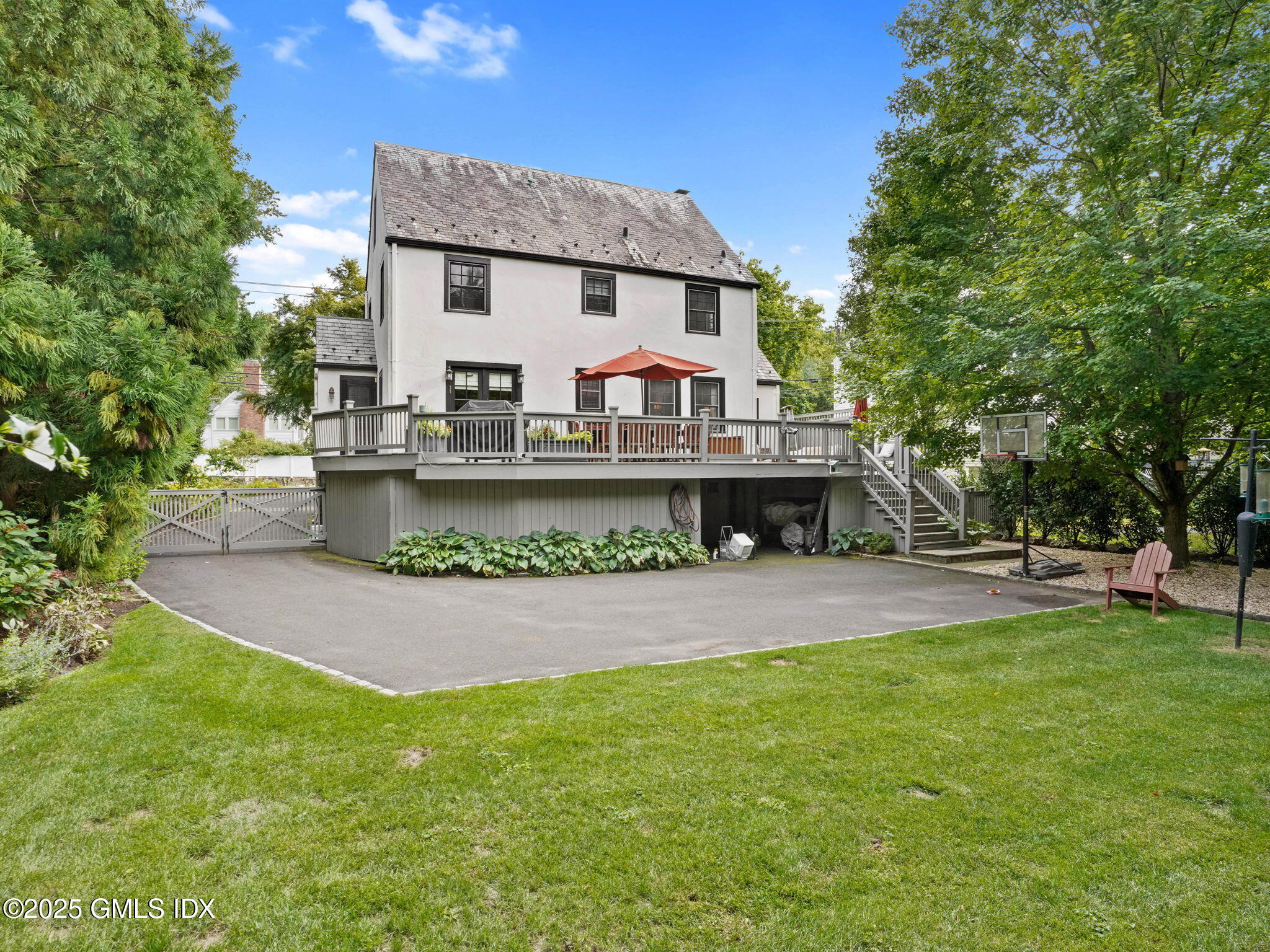 143 Lockwood Road Riverside, CT 06878 - Photo 30 of 39 a front view of a house with a garden and tree