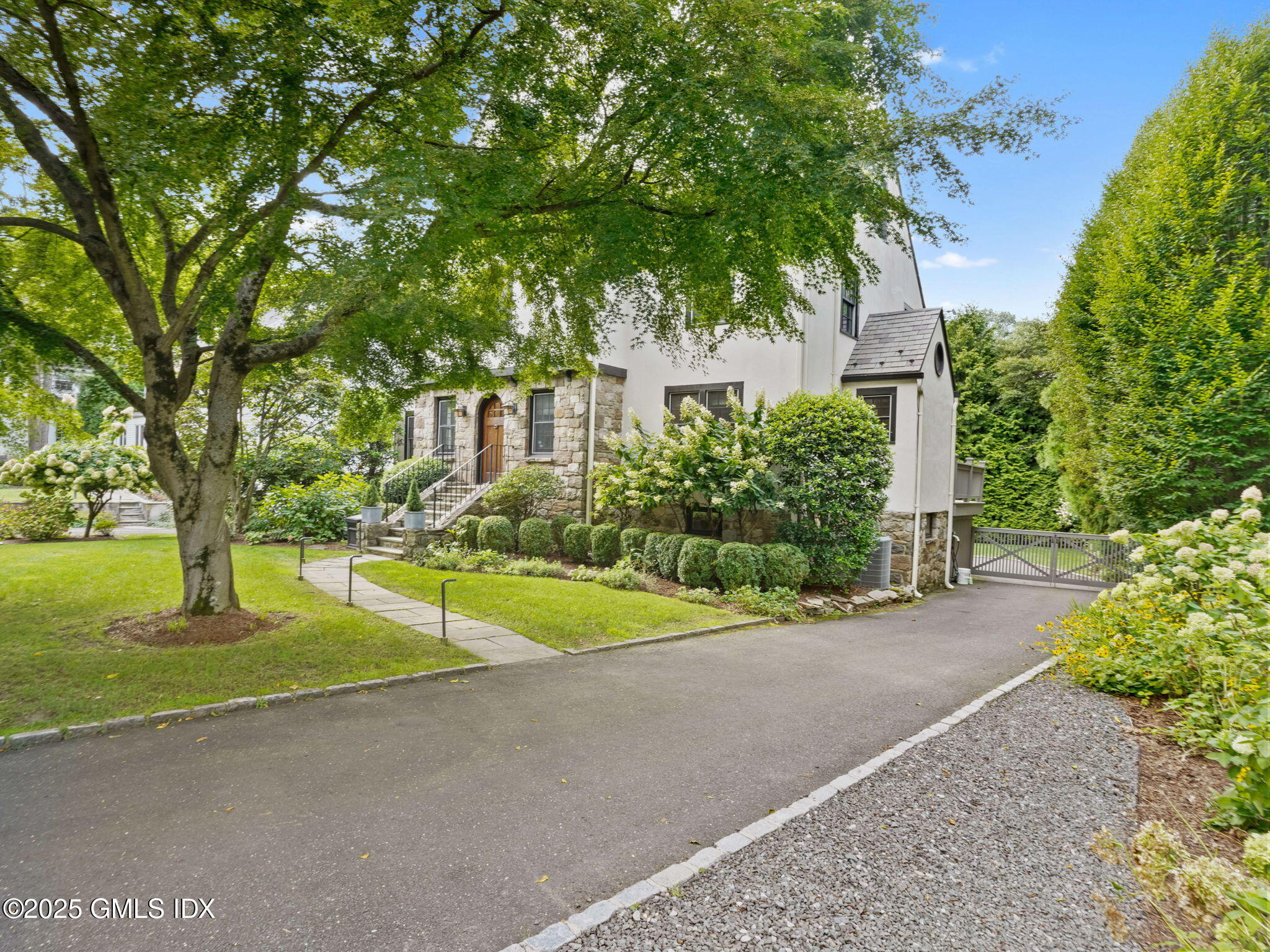 143 Lockwood Road Riverside, CT 06878 - Photo 32 of 39 a yellow house with trees in front of it