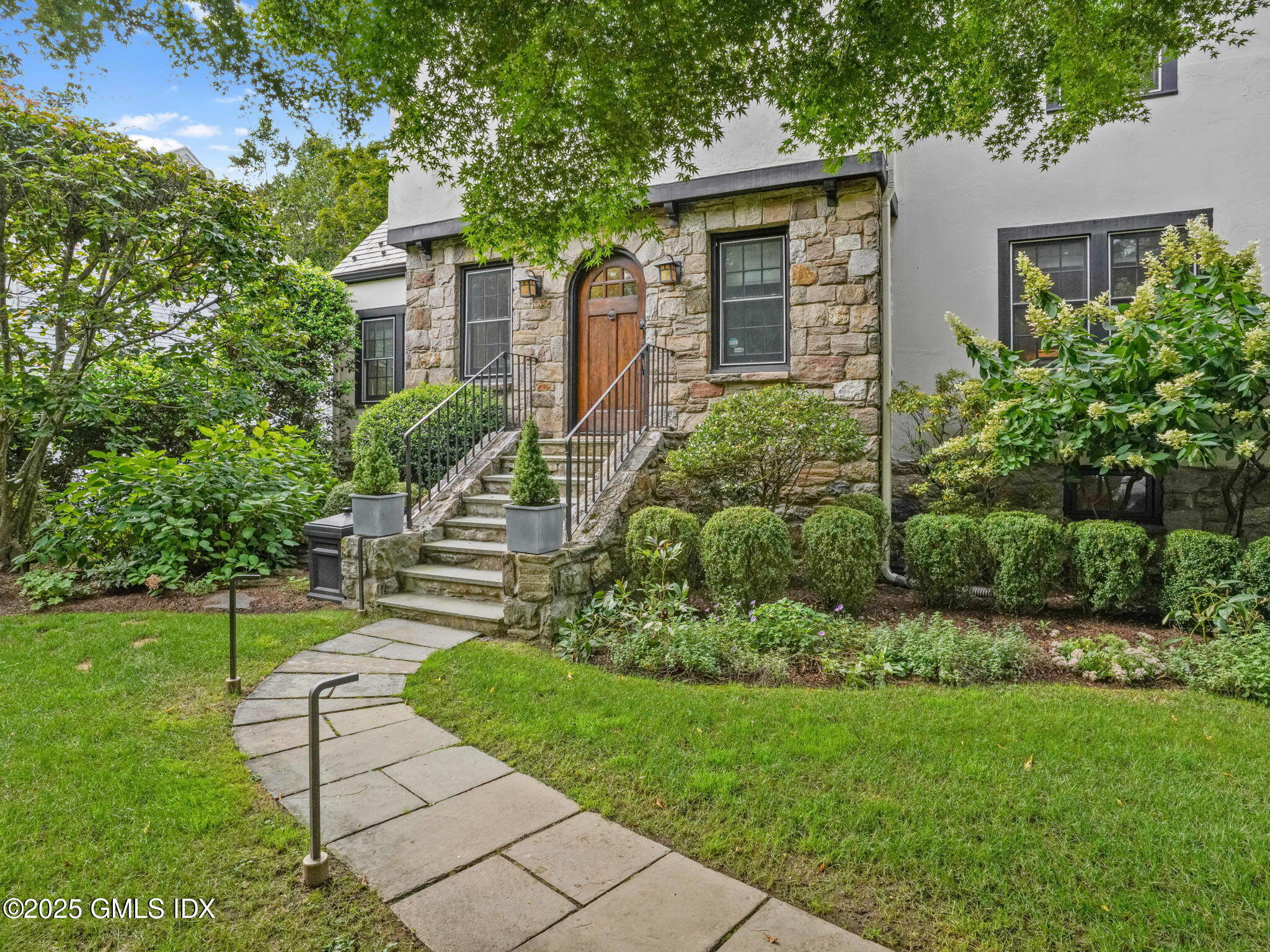 143 Lockwood Road Riverside, CT 06878 - Photo 33 of 39 a front view of a house with a yard and potted plants