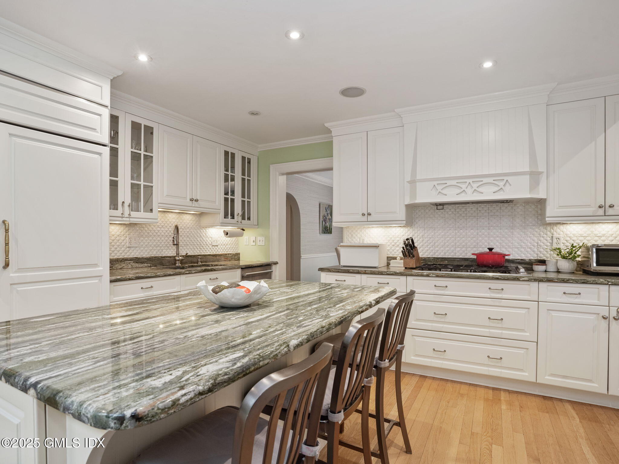 143 Lockwood Road Riverside, CT 06878 - Photo 8 of 39 a kitchen with granite countertop wooden cabinets a stove a sink and white appliances