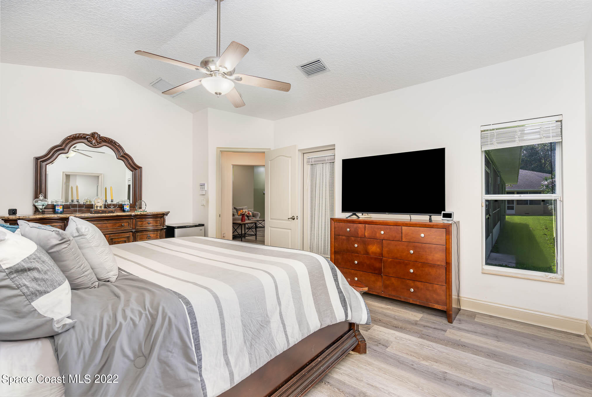 762 Seymour Road Northeast Palm Bay, FL 32905 - Photo 13 of 29 a bedroom with a bed and a flat screen tv