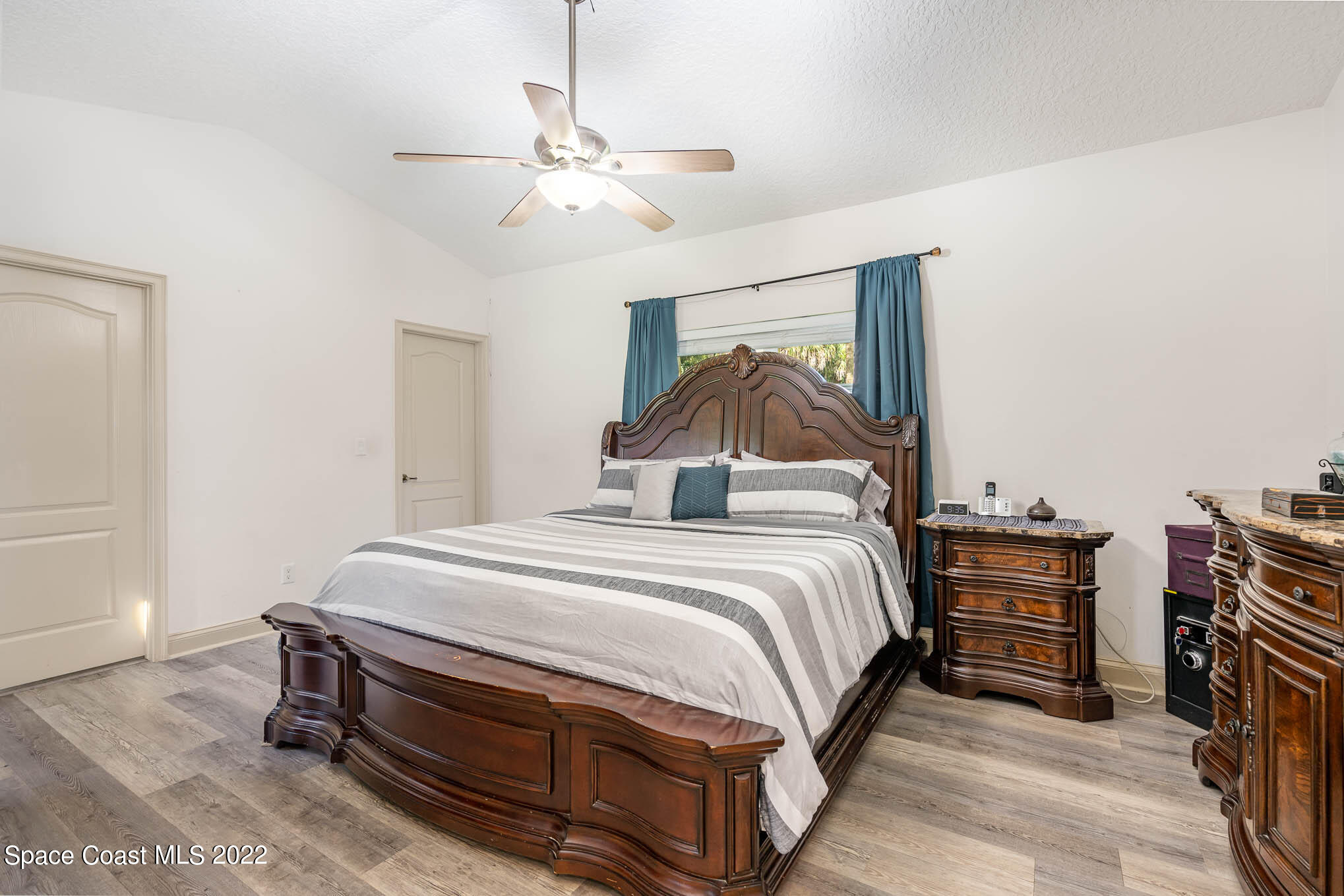 762 Seymour Road Northeast Palm Bay, FL 32905 - Photo 14 of 29 a bedroom with a bed and dresser