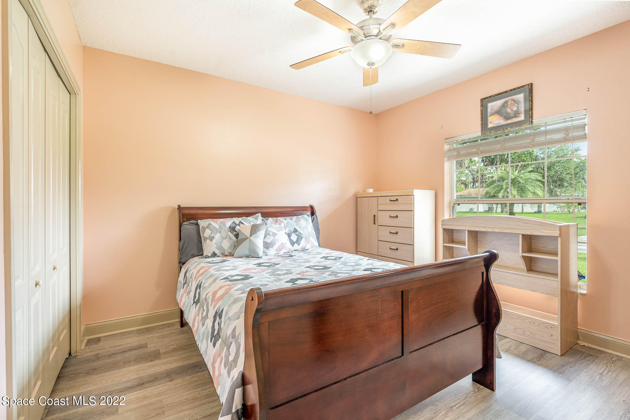 762 Seymour Road Northeast Palm Bay, FL 32905 - Photo 16 of 29 a bedroom with a bed chandelier and a window