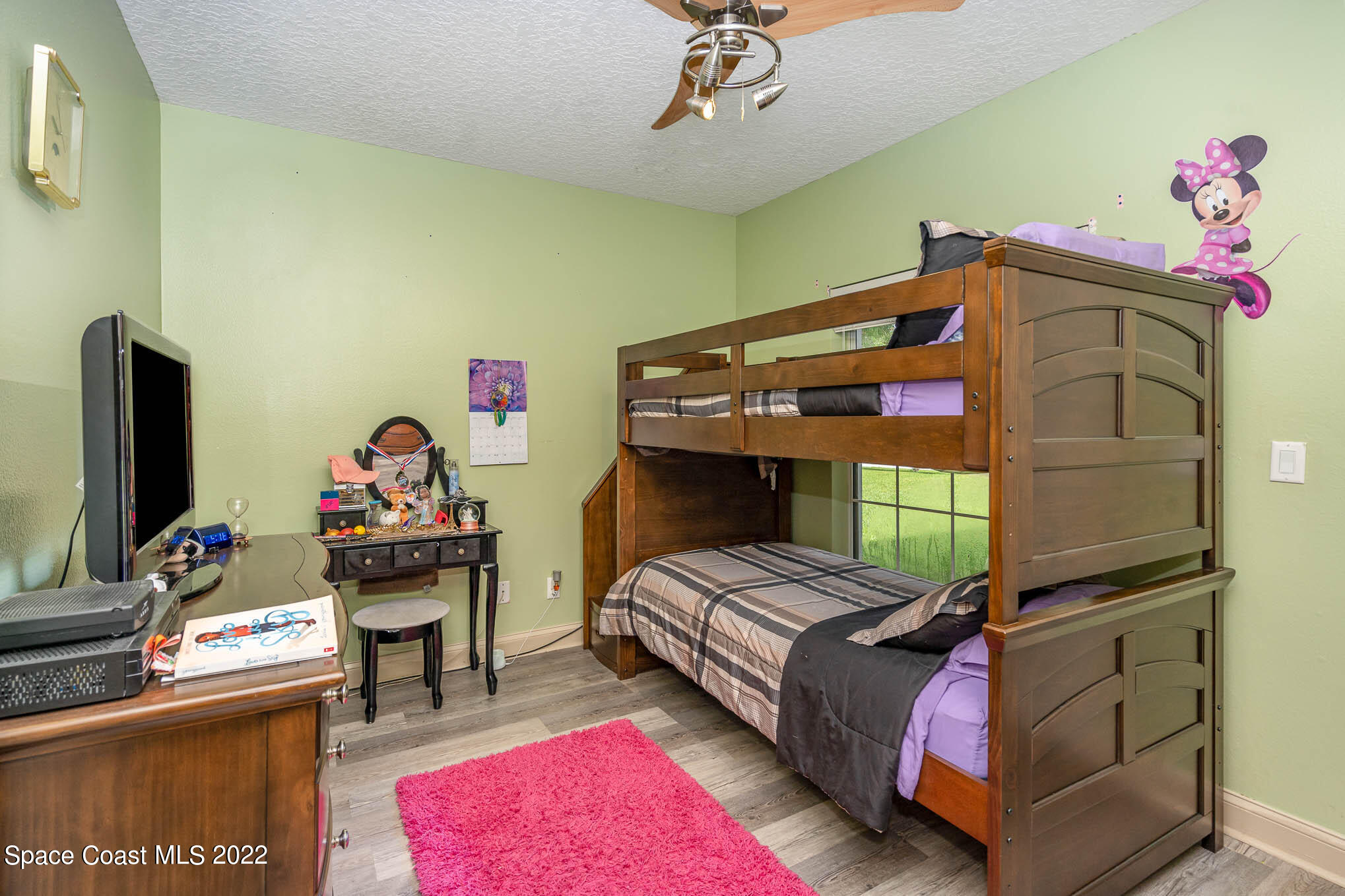 762 Seymour Road Northeast Palm Bay, FL 32905 - Photo 17 of 29 a bedroom with a bed and a flat screen tv