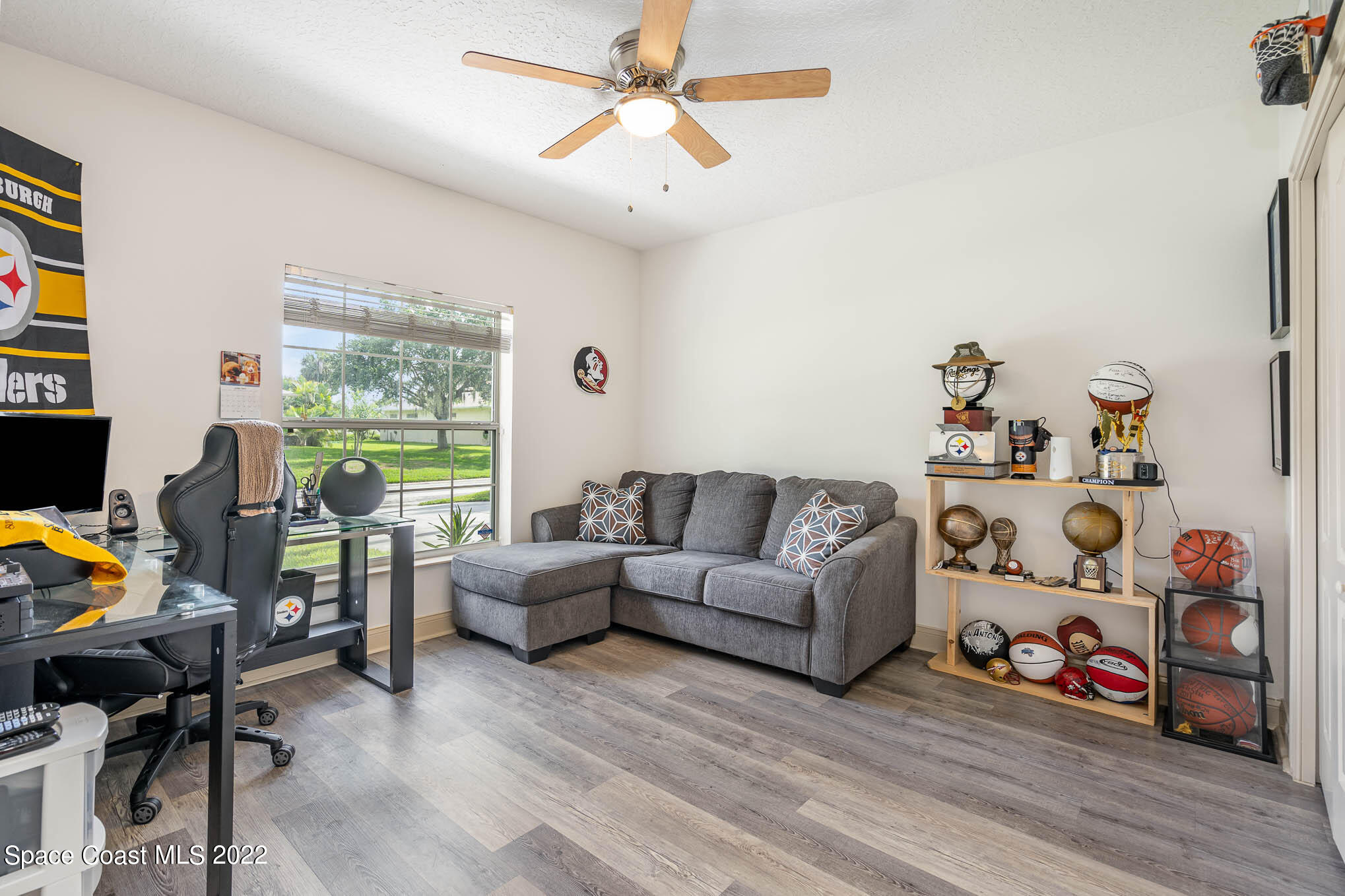 762 Seymour Road Northeast Palm Bay, FL 32905 - Photo 18 of 29 a living room with furniture a flat screen tv and a large window