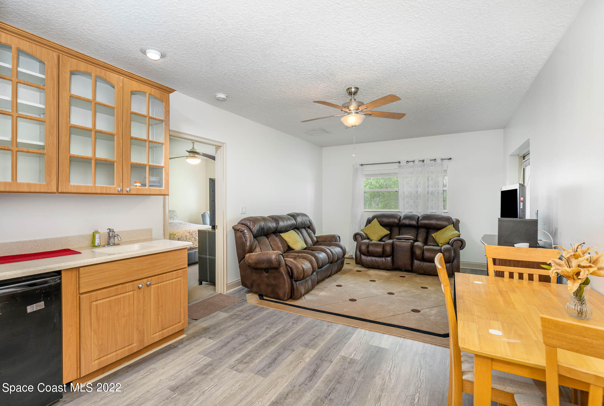 762 Seymour Road Northeast Palm Bay, FL 32905 - Photo 20 of 29 a living room with furniture and wooden floor