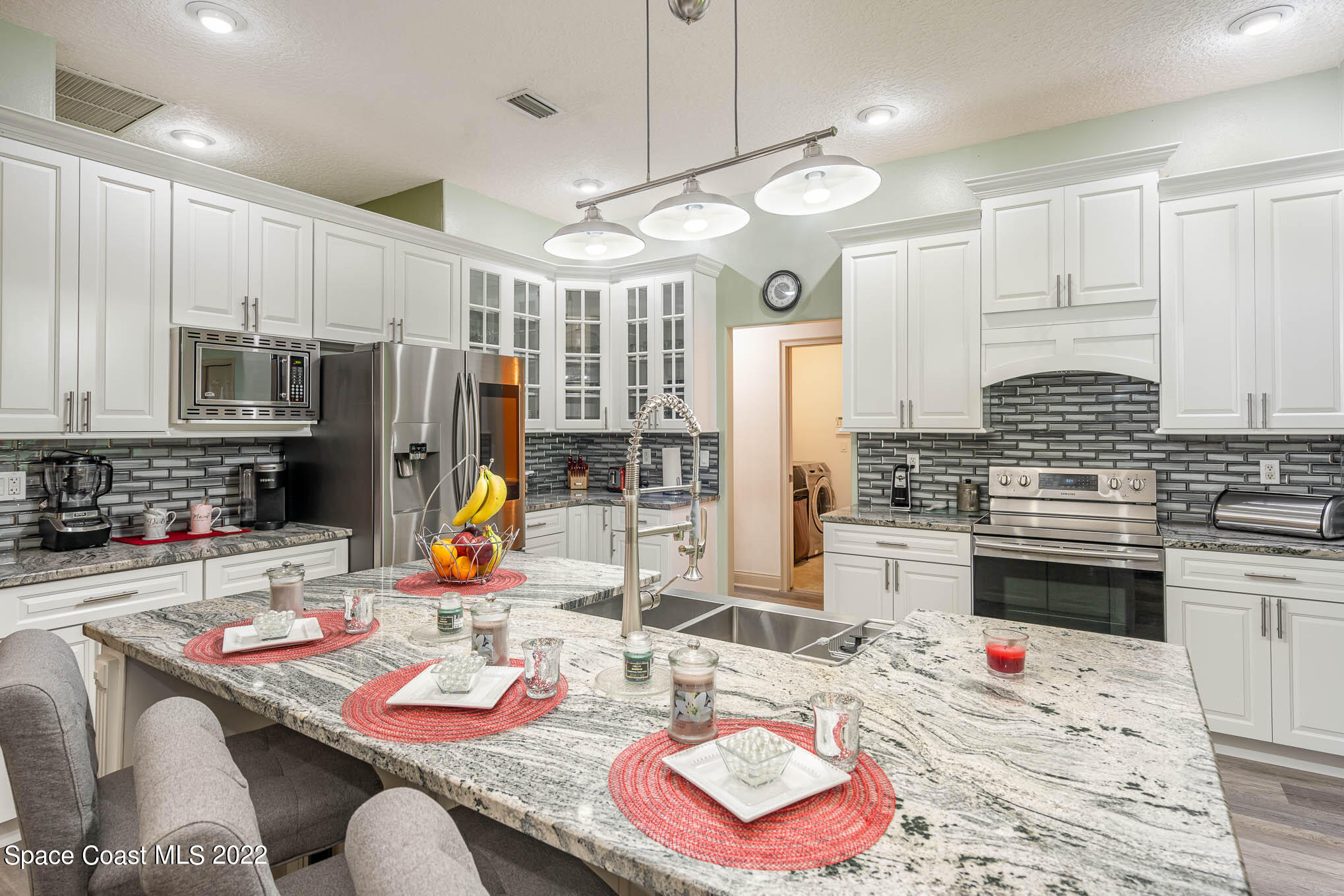 762 Seymour Road Northeast Palm Bay, FL 32905 - Photo 2 of 29 a living room with furniture appliances and a kitchen view