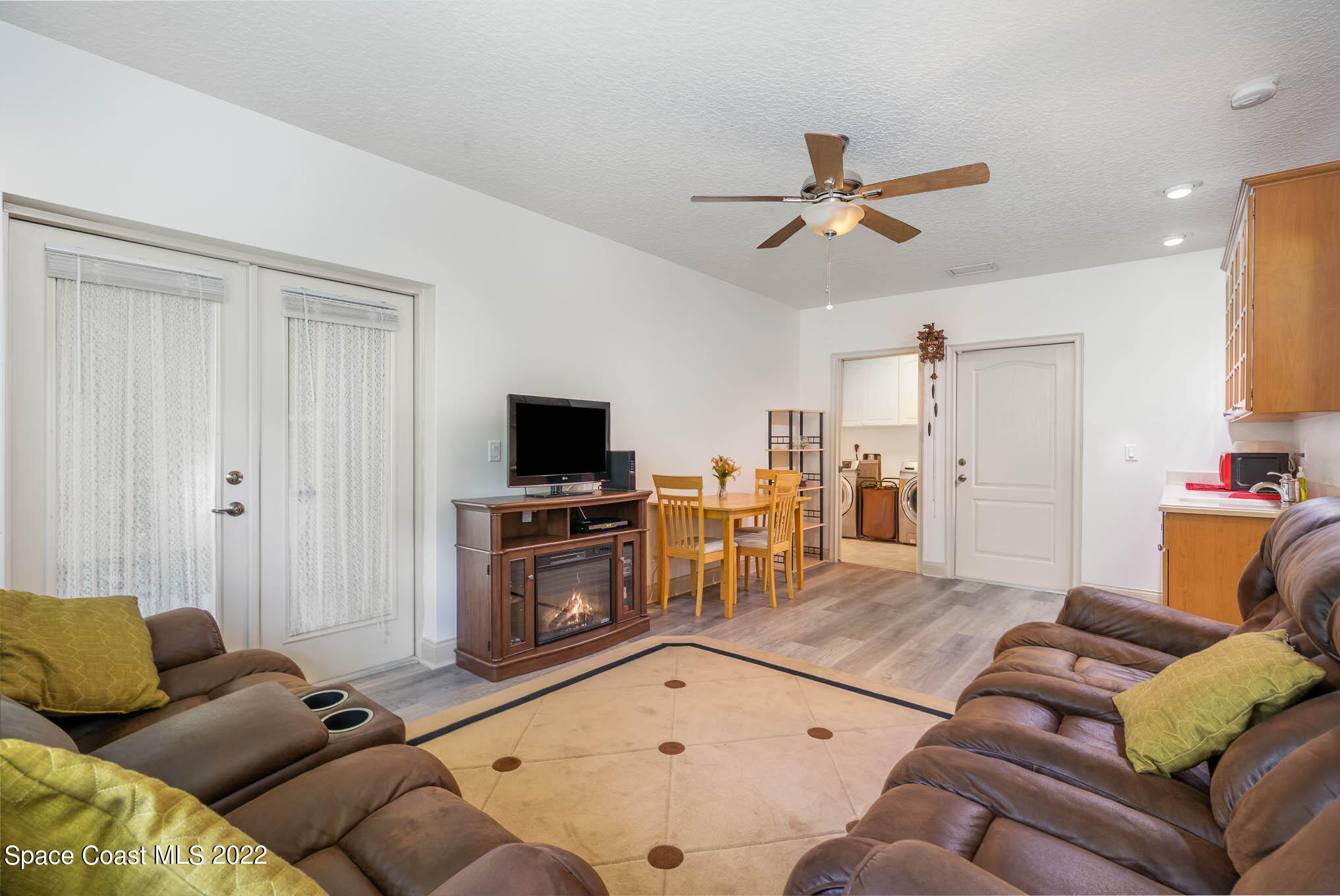 762 Seymour Road Northeast Palm Bay, FL 32905 - Photo 21 of 29 a living room with furniture and a flat screen tv