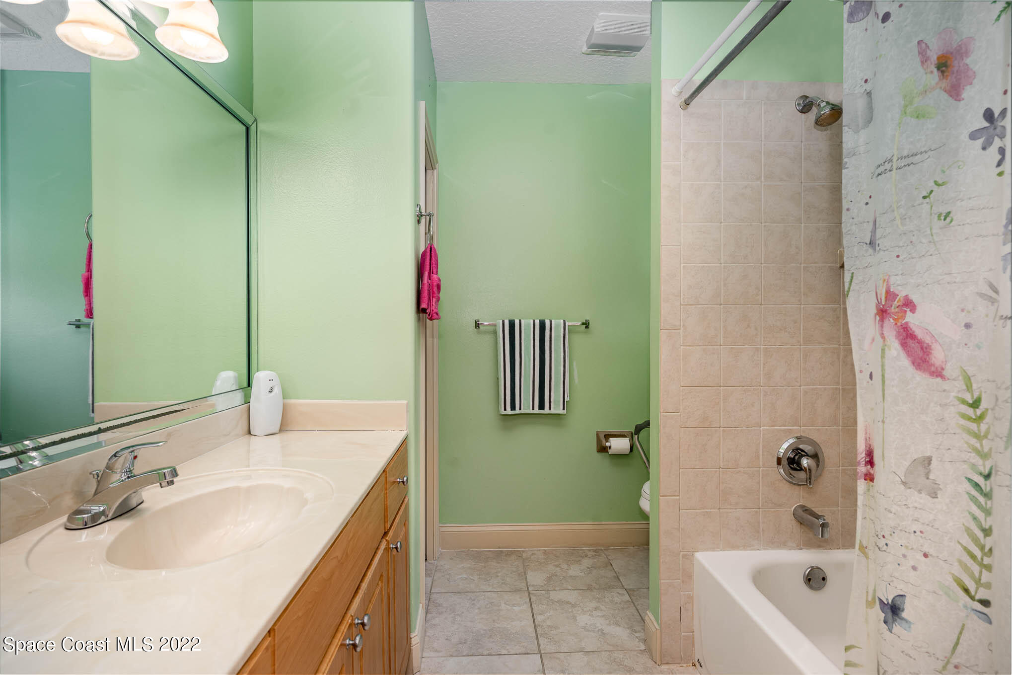 762 Seymour Road Northeast Palm Bay, FL 32905 - Photo 23 of 29 a bathroom with a granite countertop bathtub sink and toilet