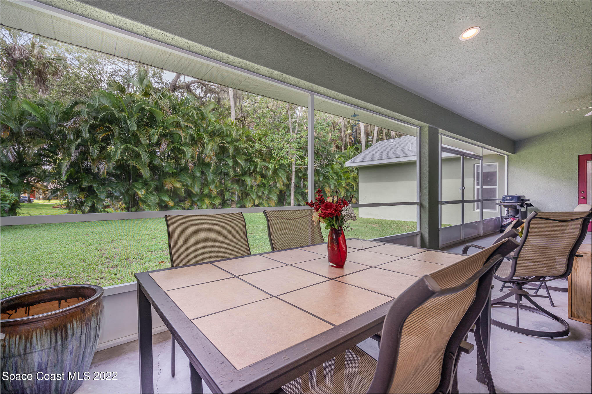 762 Seymour Road Northeast Palm Bay, FL 32905 - Photo 24 of 29 a view of a dining table and chairs in the patio