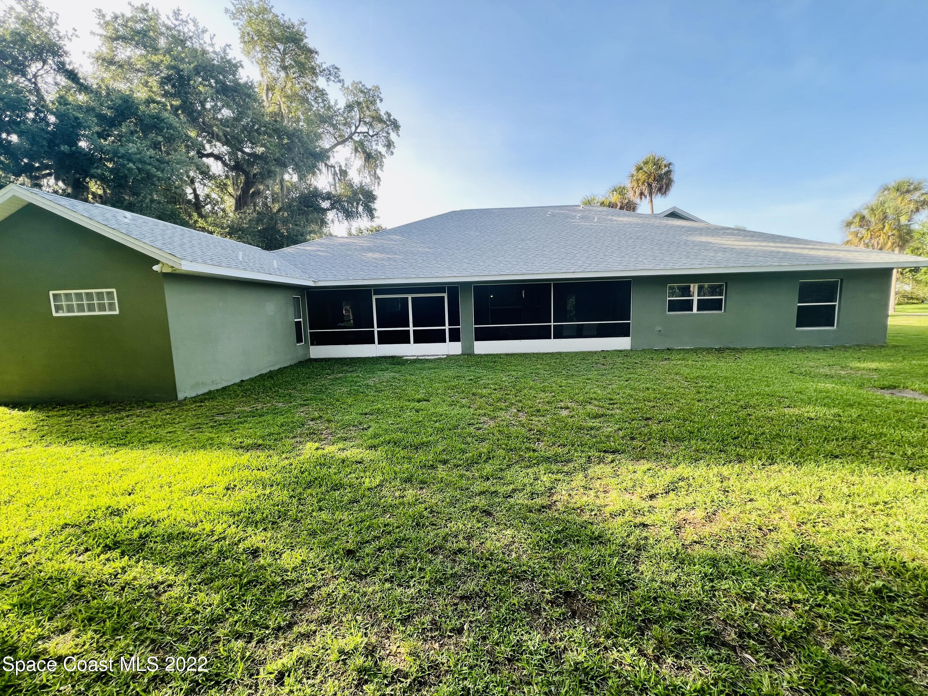 762 Seymour Road Northeast Palm Bay, FL 32905 - Photo 26 of 29 a view of a house with a yard