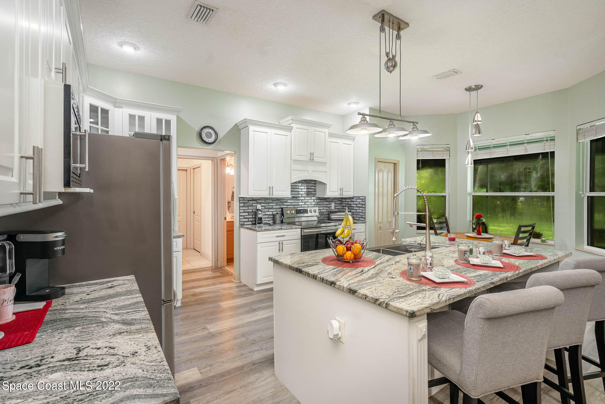762 Seymour Road Northeast Palm Bay, FL 32905 - Photo 3 of 29 a open kitchen with stainless steel appliances granite countertop a stove and refrigerator