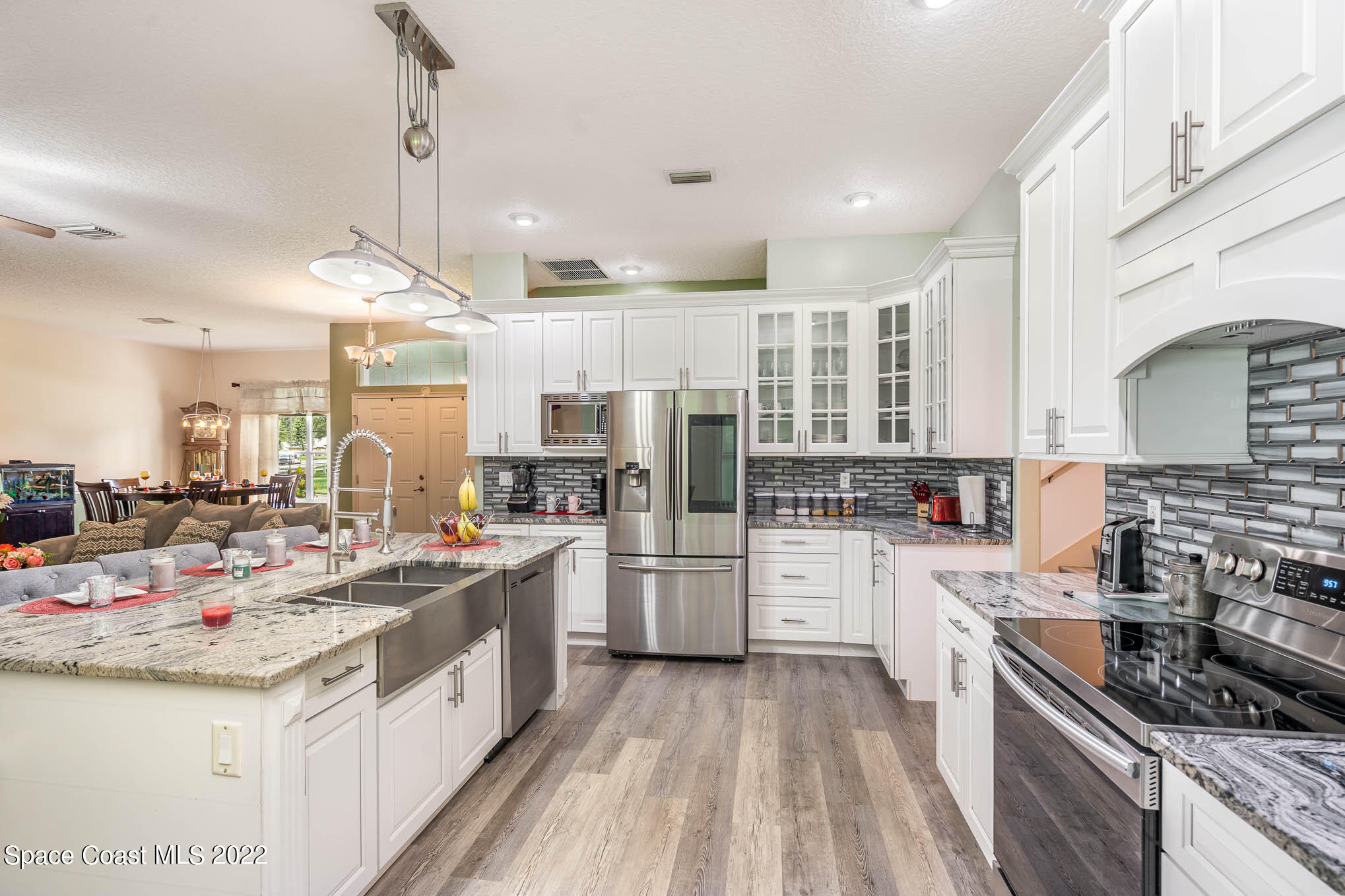 762 Seymour Road Northeast Palm Bay, FL 32905 - Photo 4 of 29 a kitchen with a sink stove and refrigerator