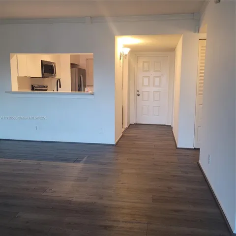 a view of a room with wooden floor and cabinet