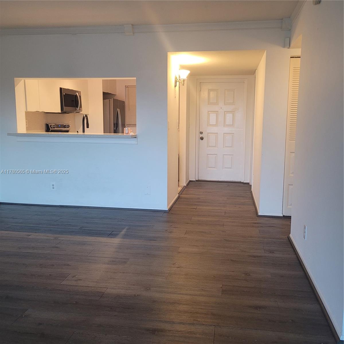 a view of a room with wooden floor and cabinet