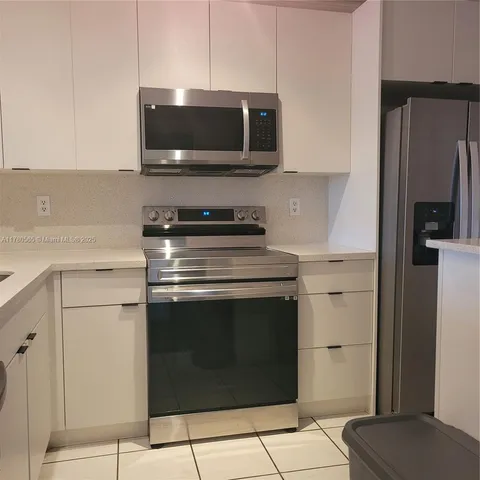 a kitchen with a stove and a microwave