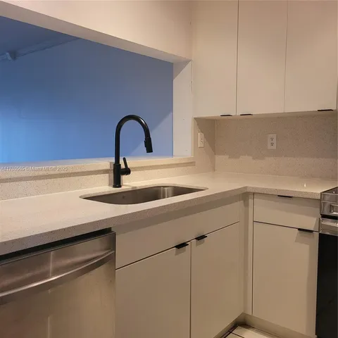 a close view of a sink and dishwasher in a kitchen