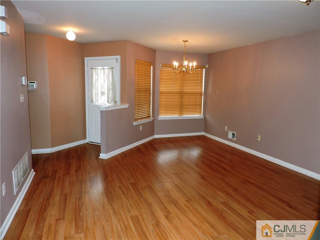 206 Hawthorne Road North Brunswick, NJ 08902 - Photo 2 of 24 wooden floor in an empty room with a window