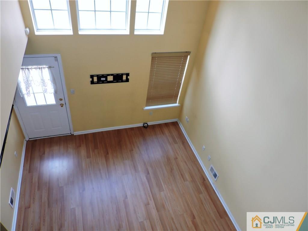 206 Hawthorne Road North Brunswick, NJ 08902 - Photo 11 of 24 an empty room with wooden floor and windows