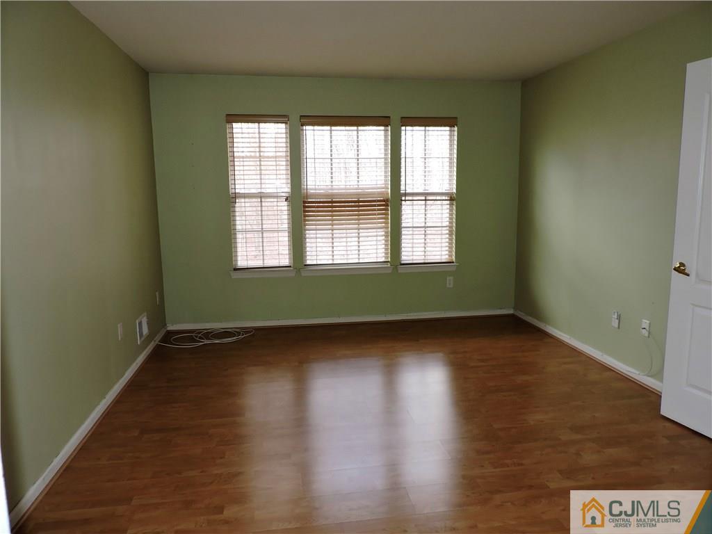 206 Hawthorne Road North Brunswick, NJ 08902 - Photo 12 of 24 an empty room with wooden floor and windows