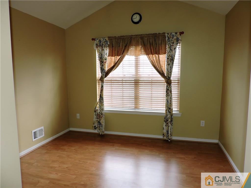 206 Hawthorne Road North Brunswick, NJ 08902 - Photo 16 of 24 an empty room with wooden floor and windows