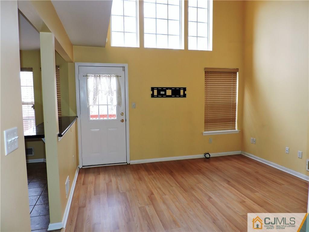 206 Hawthorne Road North Brunswick, NJ 08902 - Photo 4 of 24 an empty room with wooden floor and windows