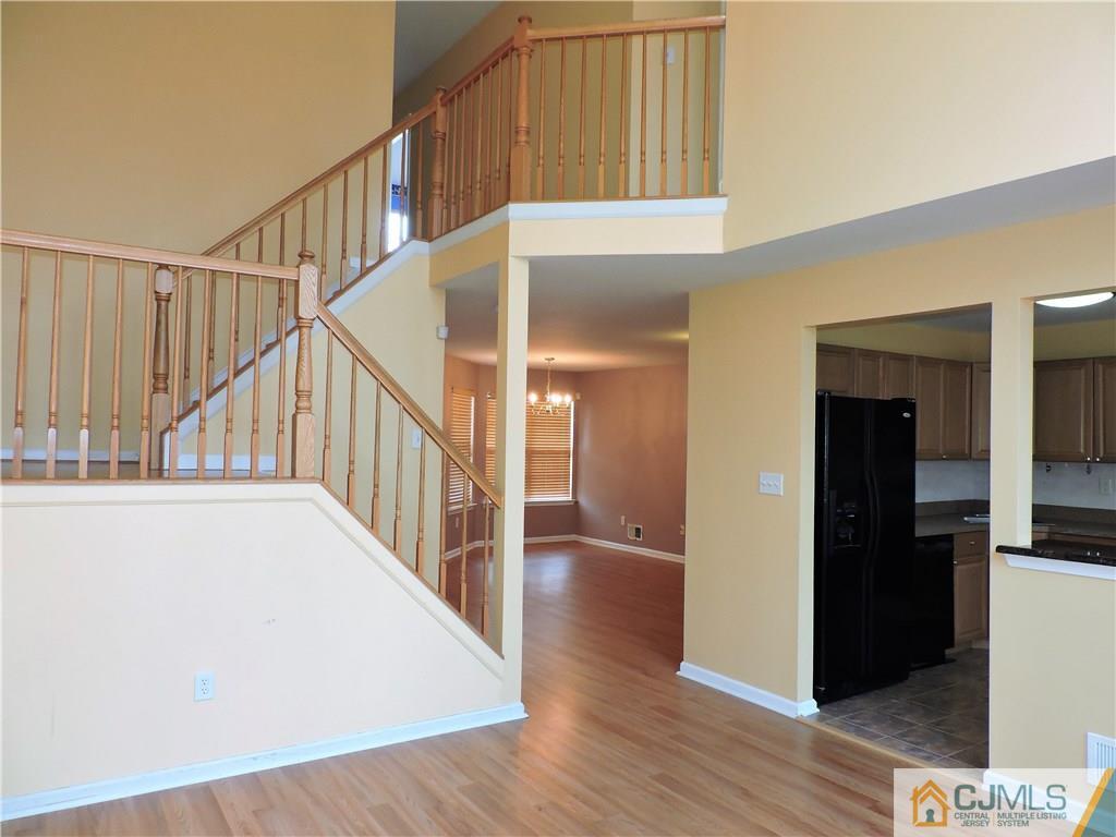 206 Hawthorne Road North Brunswick, NJ 08902 - Photo 6 of 24 a view of staircase with white walls and a window