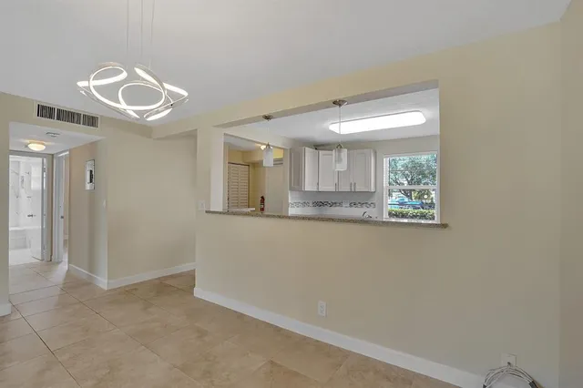 a kitchen with a refrigerator sink stove and cabinets