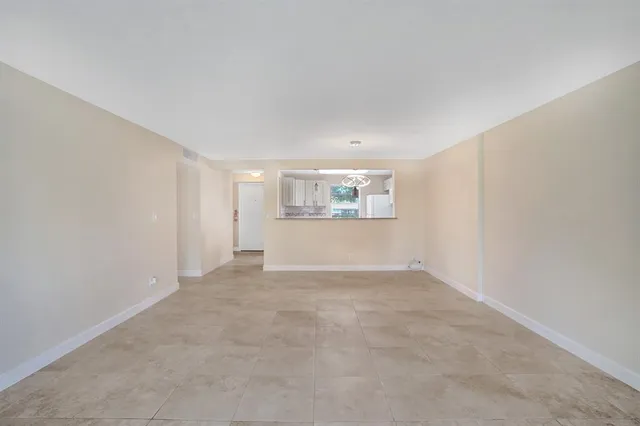 a view of kitchen with refrigerator and window