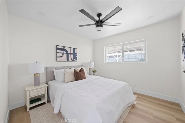 a bedroom with a large bed and a chandelier