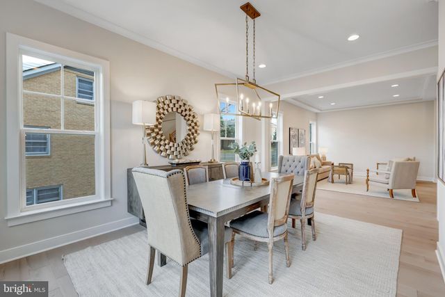 a kitchen with stainless steel appliances a dining table chairs and stove