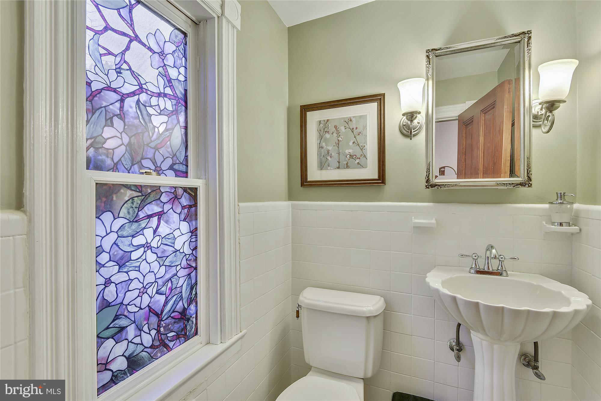 2200 Salisbury Road Silver Spring, MD 20910 - Photo 11 of 26 a bathroom with a sink and mirror with toilet