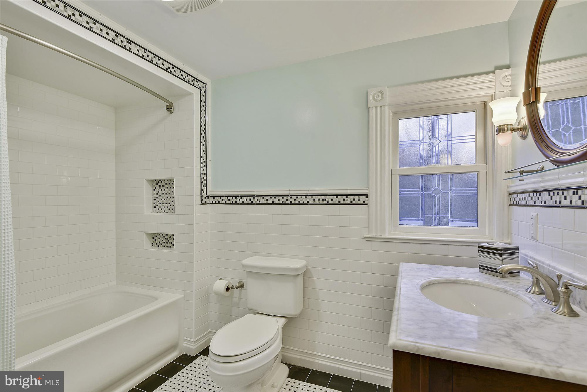2200 Salisbury Road Silver Spring, MD 20910 - Photo 12 of 26 a bathroom with a granite countertop sink a toilet and a bathtub
