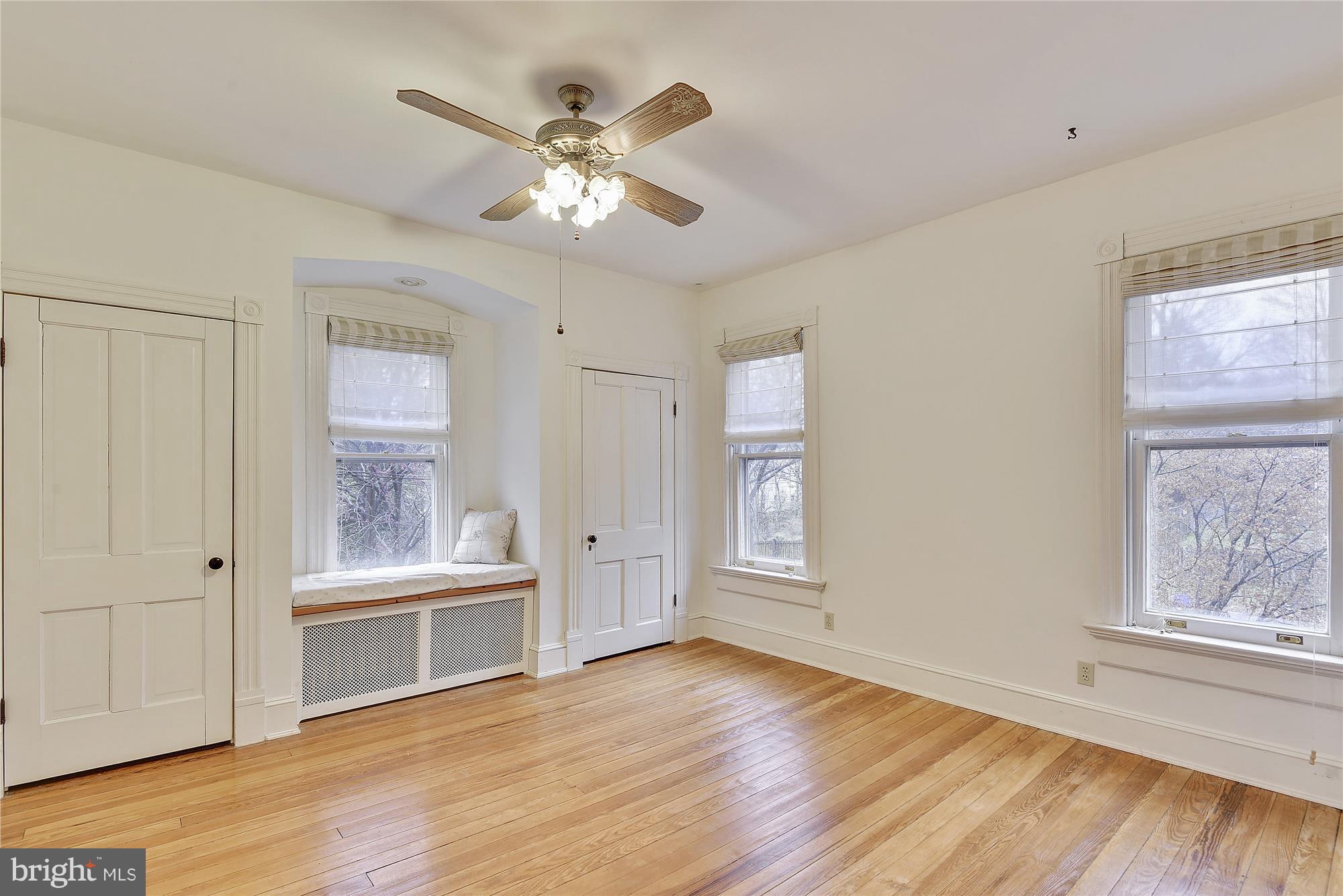 2200 Salisbury Road Silver Spring, MD 20910 - Photo 13 of 26 a view of an empty room with a window and wooden floor