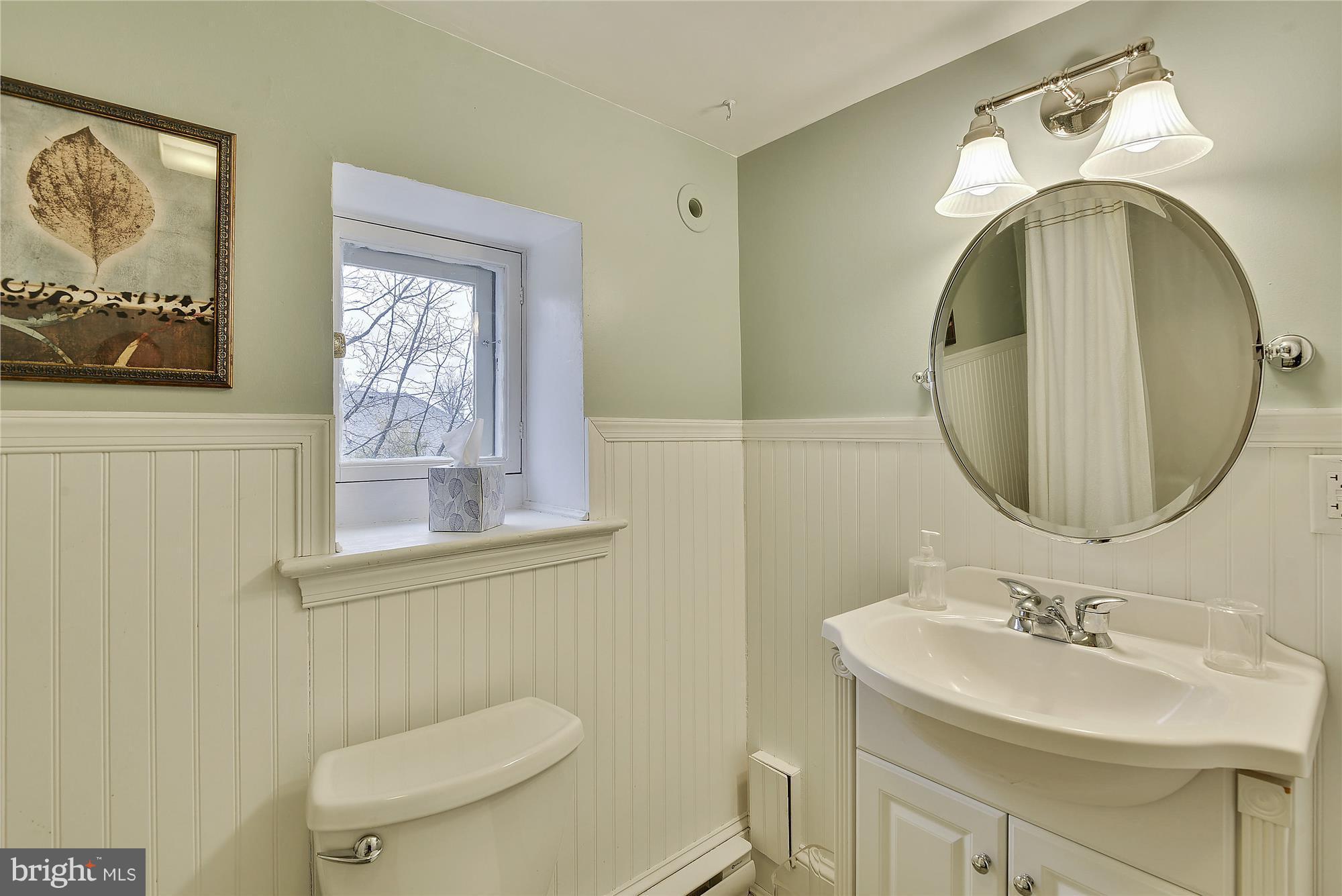 2200 Salisbury Road Silver Spring, MD 20910 - Photo 9 of 26 a bathroom with a toilet a sink and mirror