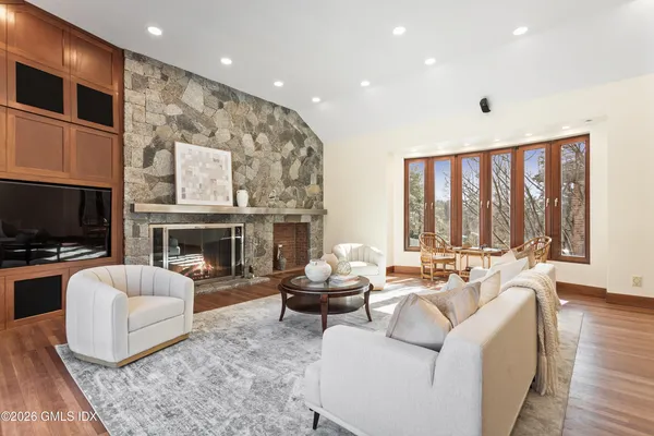 a living room with furniture fireplace and flat screen tv