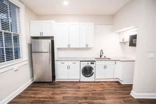 a kitchen with stainless steel appliances granite countertop a refrigerator sink and stove