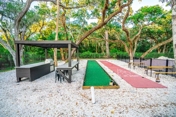 a view of a patio with a table chairs and a backyard