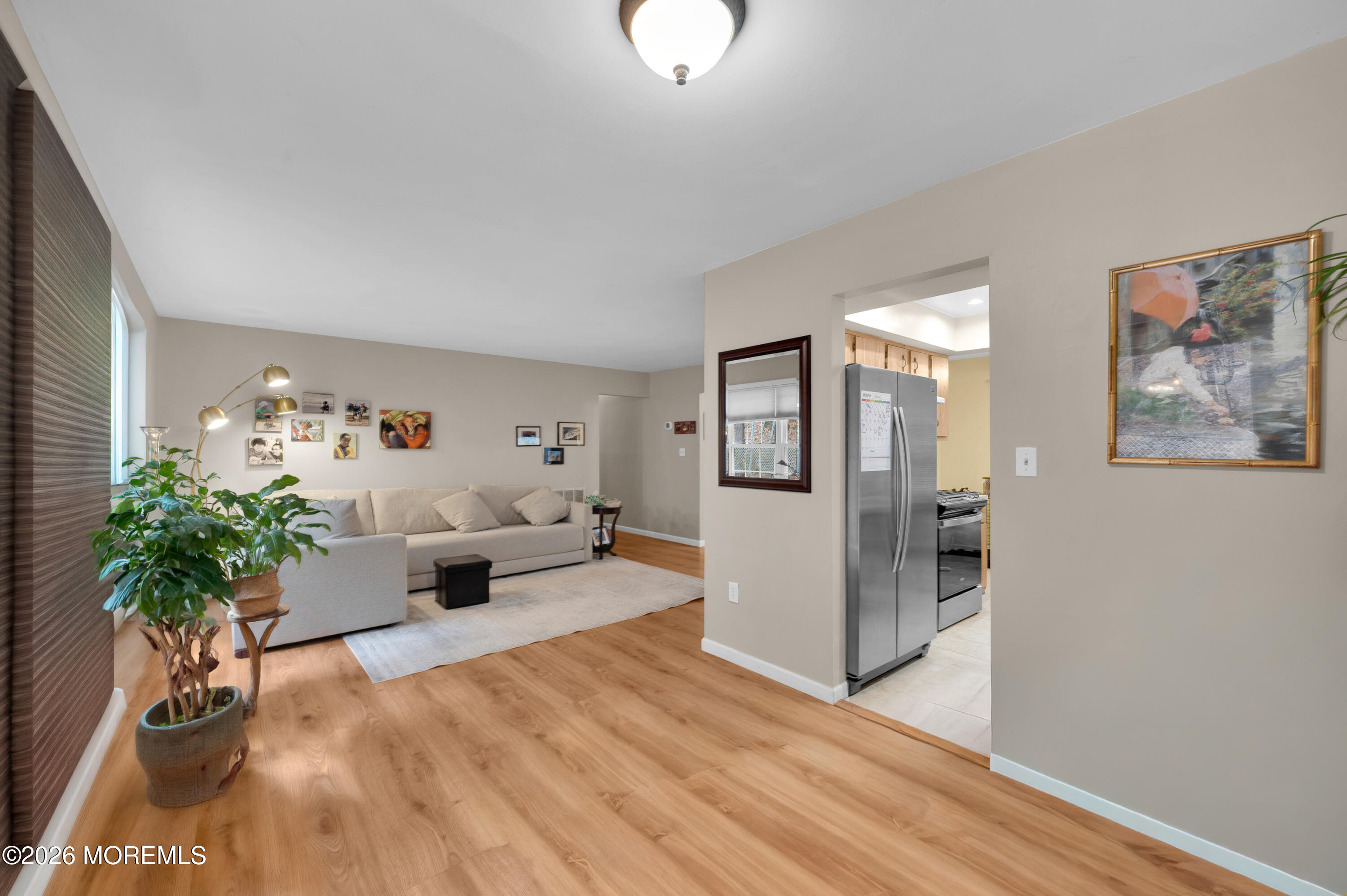 7 Deck Court Howell, NJ 07731 - Photo 17 of 29 a living room with furniture and a chandelier